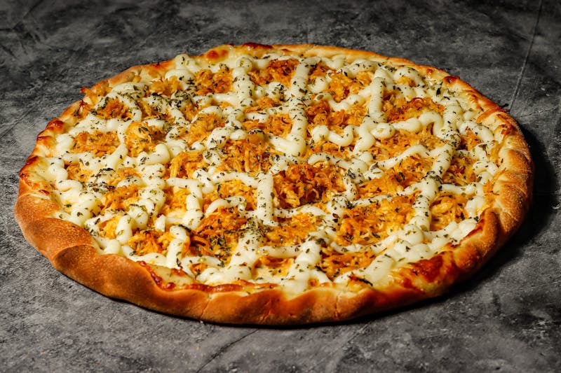 BBQ chicken round table pizza with caramelized onions